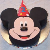 Mickey Mouse Cake 10 inch head and 6 inch ear cakes covered in fondant. Hat is a real party hat covered in fondantClient came earlier than expected and I was...