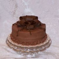 Chocolate Cake 8 inch round chocolate cake. Brown fondant bow.