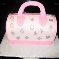 Pink And Silver Handbag Cake for a young lady who was turning 16 yrs old. It's supposed to be modeled after a Louis Vuitton bag. She wanted her initials...