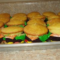 Cheeseburger Cupcakes Classic yellow cupcakes, devils food and irish creamer for cake ball patties, green, yellow, and red buttercream, orange fondant for cheese...