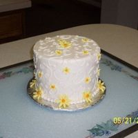 Yellow Daisies This is a 6-inch cake in buttercream with yellow fondant daisies, C-scrolls, and dots. Thanks for looking!