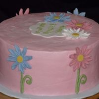 Daisy Cake 2 layers (12") of zebra cake, iced in light pink buttercream and topped with fondant daisies.