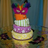 Mardi Gras Quinceanero Four tier topsy turvy cake, covered in fondant with a MardiGras theme (just not the traditional colors)