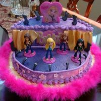 Bratz Birthday Stage cake with Bratz performers. Mock whip frosting, airbrushed, with fondant accents.