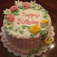 Spring Birthday Basketweave, leaves, and writing is buttercream icing; roses and lillies is royal icing.