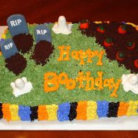 Boorific Birthday Halloween scene with fondant tombstones and ghosts, candy corn pumpkins, and crushed brownie bits for the dirt.