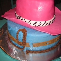 Pink Cowgirl Hat cake for my goddaughter 11th bday. for the hat 3 8in stack cakes and shape like a cowboy hat. covered in mmf. bottom is 2 12 in cake...