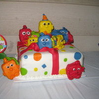 Opened Gift I want the cake to look like a present with the mini monster coming out. cake covered in mmf. Monsters are made out of rkt. covered in mmf...