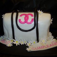 Large Chanel Purse It is a white cake covered in MMF with MMF accents and gumpaste flowers. This was made for my MIL's surprise birthday party and...