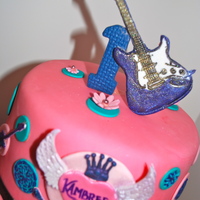 Top Of The Cake For Kambree's 1St Birthday 1st. birthday guitar, crowns, stars and flowers. Purple, hot pink, black and teal.