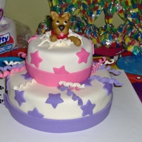 Dog Comes Out Of Cake! Made this for my daughter's 6th birthday this weekend. It's yellow cake with almond flavored syrup, and covered in MMF. This was...