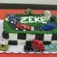 Disney Cars Birthday Cake 2 layer 13x9 inch cake iced with BC, fondant race track and real toy cars.