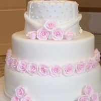 Pink Roses Wedding Cake this was a white wedding cake with white chocolate raspberry buttercream filling. i was extremely sick when i did this and i rushed a lttle...