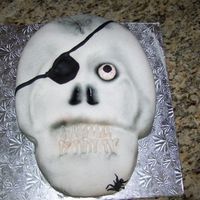 First Skull here is my first attempt at a skull. i covered it with fondant and made the teeth from gumpaste. hope you like it!