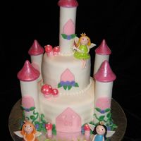 Fairy Castle I made this cake for a 4 year old that asked for a castle with 3 fairies, it is a vainilla cake with almond flavor.