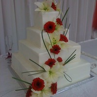 Brittany's Wedding Cake Square, 4 tiered, with buttercream icing. Edible pearl trim, real flowers