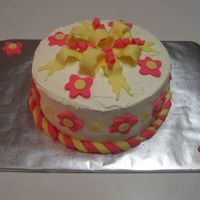 Birthday Present BC with fondant bow, flowers and trim.