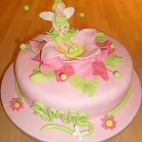 Tinks! 9" white chocolate and strawberry cake covered in fondant with mexican paste tinkerbell and flower. Poor tinkerbell ended up with...