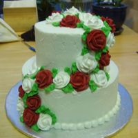 40Th Anniversary Cake 9" and 6" wasc cake french vanilla mousse filling with buttercream frosting. The roses are RI.
