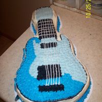 Electric Guitar Wilton Pan, all ButterCream Dream. I wrote the guys name on the side (turned out bad) and stuck a real blue guitar pick next to it. Would...