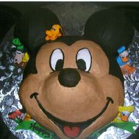 Mickey Mouse Mickey is all butter cream and the small characters are hand molded from fondant.