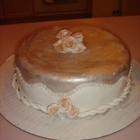 Dsc05095.jpg this cake was fun to make fondant covered yellow butter cake, painted with gold and silver luster dust finished with edible pearls..TFL