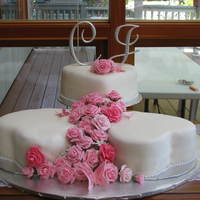 Christine's Wedding Cakes Heart shaped cakes, pink roses and butterfles. Chocolate, White and butter pecan cakes, butter cream, fondant covered, hand made fondant/...