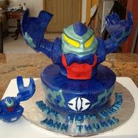 Bakugan Cake Body is RKT covered in fondant and then painted with watered down paste icing color royal blue. The green is petal dust & white pearl...