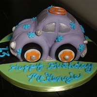 Mckenzie's Vw Bug Cake carved from 2 8" round strawberry cakes. Ended up being about 8 long by 4 1/2 wide by 6 1/2 tall. Covered with homemade vanilla...