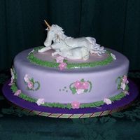 Unicorns Inspired by JaneK's unicorn and fairy cake. Hand modelled unicorns from gumpaste, gumpaste flowers. Cake is chocolate cake covered in...