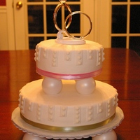 With This Ring This cake is covered with buttercream with fondant and royal icing details. They es are vanilla cakes with a strawberry creme filing.