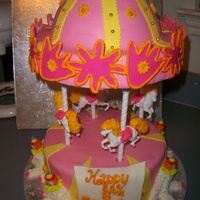 Pink And Yellow Carousel Cake I loved the end result of cake! This was a red velvet cake on the inside and I used the new wilton carousel kit, without the top part. TFL...
