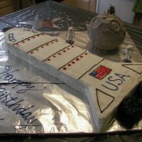 Space Cake Half Sheet cake cut to make the space shuttle. Ran out of frosting, so only a "crumb coat" is on the shuttle. Would have looked...