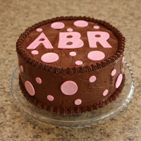 Dots 10 inch double chocolate and vanilla chocolate chip with Martha's Ultimate Chocolate Frosting with intials and dots in gumpaste dusted...