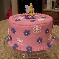 Tinkerbell Double layer yellow cake with chocolate chips frosted with cream cheese frosting. Flowers are royal. Tink is a candle. I made the cake to...