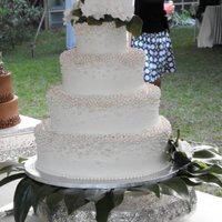 Pearl Cake 4-tiered buttercream round cake with fondant pearls. The flowers are made of paper.