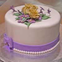 Simple Floral Birthday Cake Chocolate cake covered in fondant, gumpaste flowers.