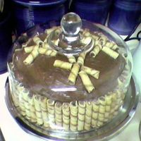 Pirouline Cake Yellow cake with chocolate butter cream frosting, decorated with Pirouline cookies. This was my first cake attempt in 10 years. My friend...