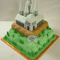 Harry Potter Hogsworth Castle 18 inch bottom iced with buttercream, 14 inch top tier covered with fondant. 3 building on top are cake. Roof tops and round building are...