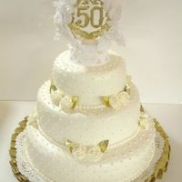 50 Wedding Anniversary Cake This cake is iced with buttercream and trimmed with buttercream roses.