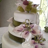 Calla Lillibration Three-tiered fruit cake with waterfall drapes and lilly sprays accented by green banding.