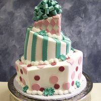 Topsy-Turvy Cake White butter cream cake with fondant loopy bow and fondant decorations. I liked that this cake didn't have too many colors going on.