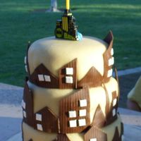 Marzipan Gotham City 12-10-8" covered in marzipan, w/ fondant city cutouts. Decorated in less than an hour, that's all the time I ended up with before...