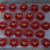 Elmo Cupcakes All iced w/buttercream. I used a star tip and pulled it out a bit for more fuzzier hair. The rest was piped on.