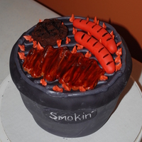 Grill Cake Grill cake with Fondant hot dog, fondant ribs, and brownie hamburger. Grill is yellow cake covered in fondant.