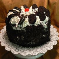 Cookies & Cream Devil's Food Cake with Chocolate cream filling, Whipped Topping icing with Oreo cookie crumbs on side & decorated with Oreos,...