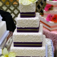 Yellow Lily This is another wedding show cake. Royal icing scrolls on an ivory fondant finish.