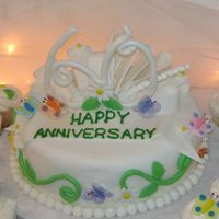 60Th Wedding Anniversary Vanilla cake with buttercrem icing. Cake is covered in fondant. Butterflies and flowers are also fondant. Also made matching cup cakes. The...
