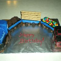 Birthday Train Another birthday for my nephew. Made from mini loaf pans, then carved the caboose and engine. Covered in buttercream (SO hard to get it...