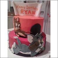 Tom & Jerry tiered cakes with fondant cutouts of tom & jerrry